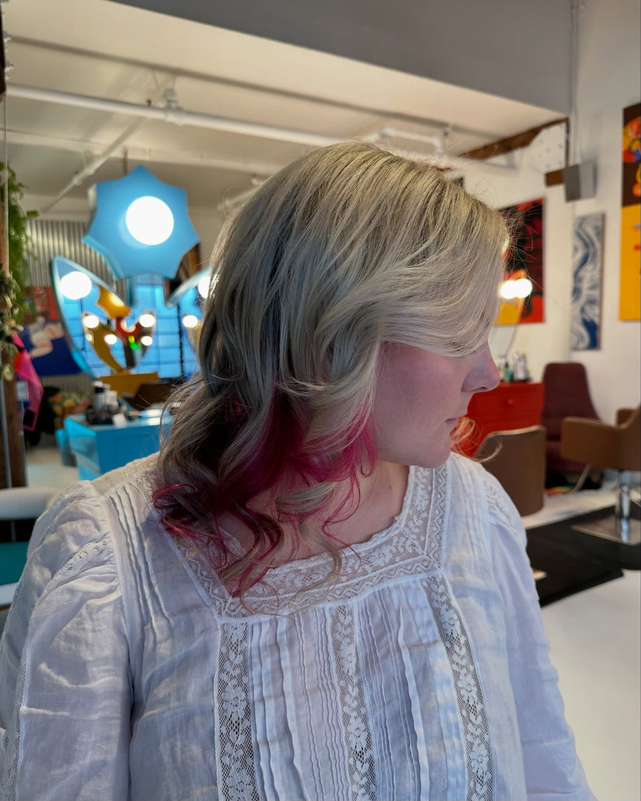 Blonde layered hair with pink peekaboo color by Ella Park at Hair Los Angeles